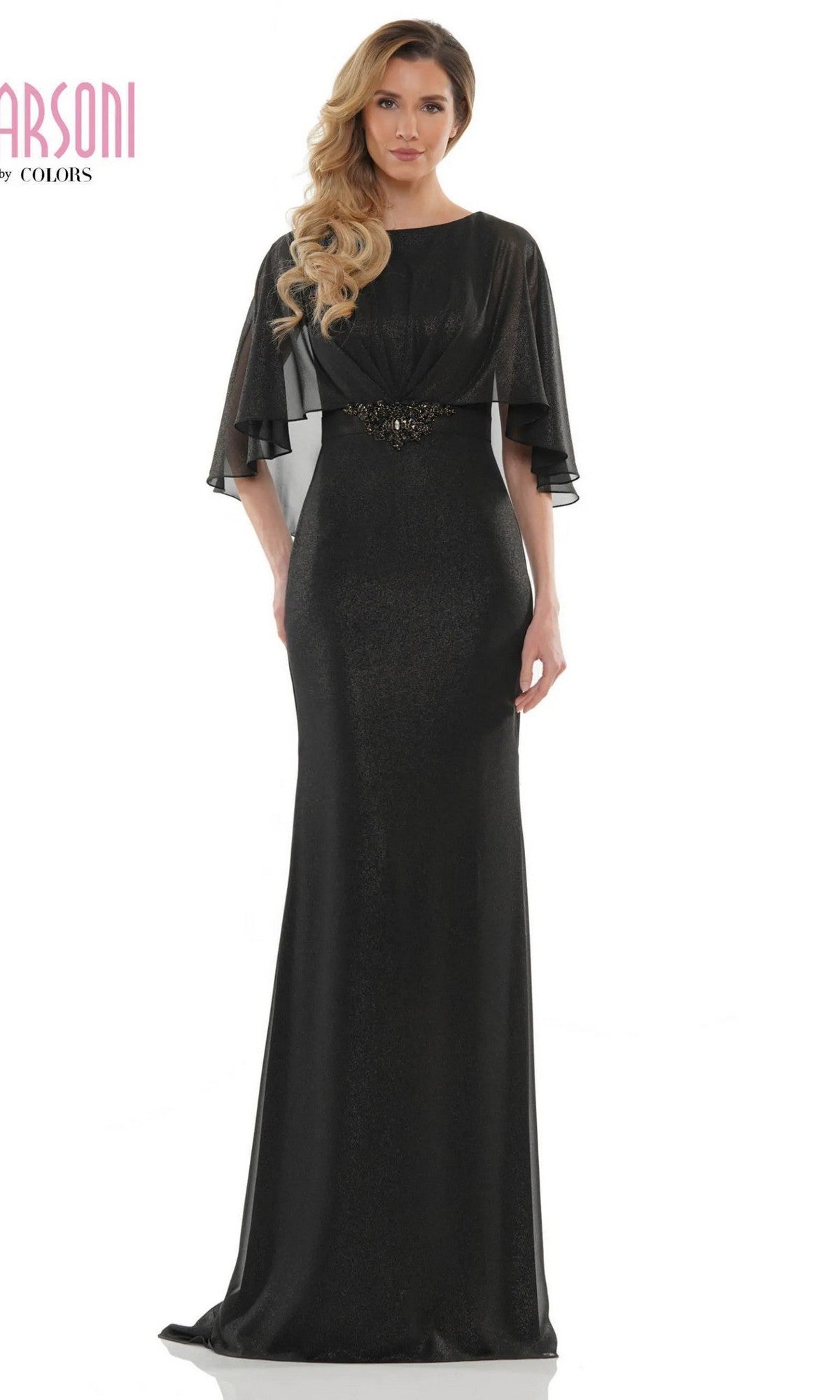 A woman stands against a plain white background wearing the Marsoni MV1130, a floor-length formal sheath dress with sheer flutter sleeves and a jeweled belt at the waist.